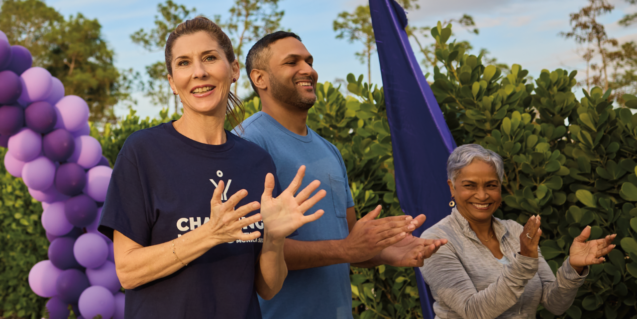 Monica smiles and chats with members of the gMG community while participating in an awareness walk.