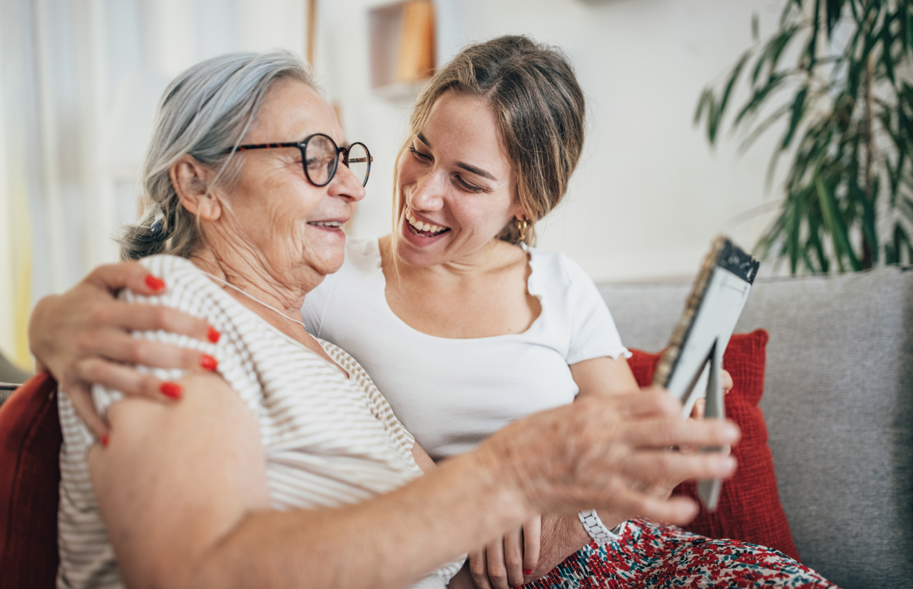 A couple sitting on a couch and smiling at each other