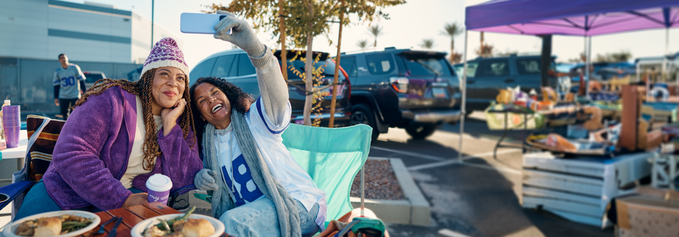 Two women tailgating a football game.