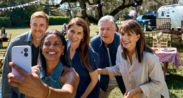 Members of the gMG community gathered together, taking a selfie at a picnic.