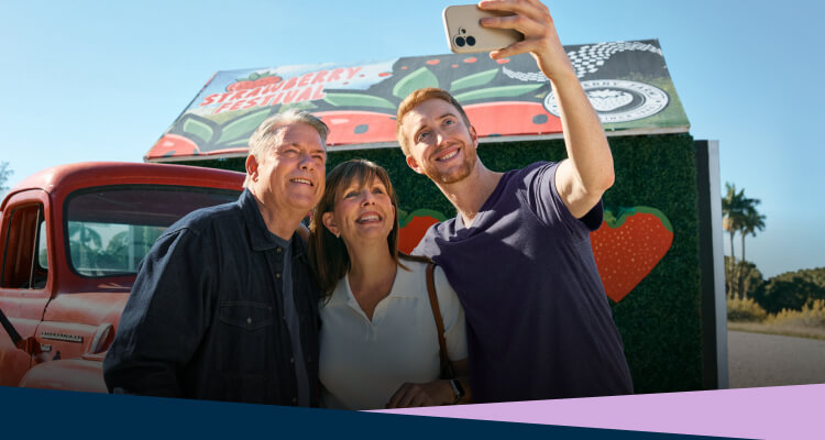 Ken and his family take a selfie in front of a roadside farmstand.