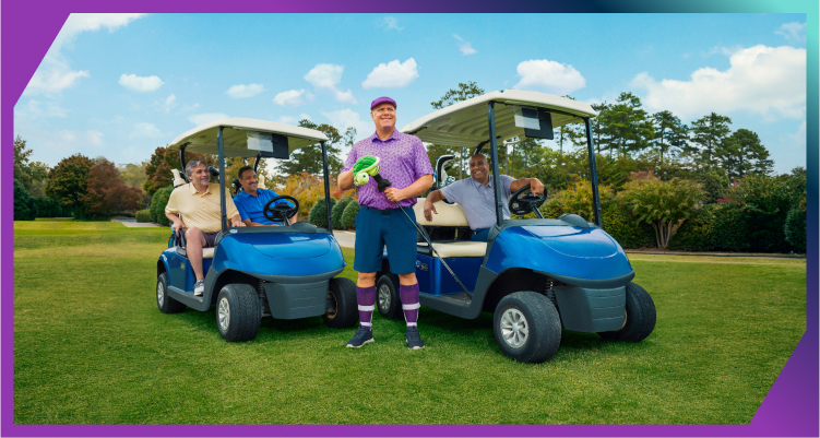 A group of men on the golf course, some in golf carts and one standing